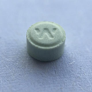 Extreme closeup photograph of an Ativan pill.